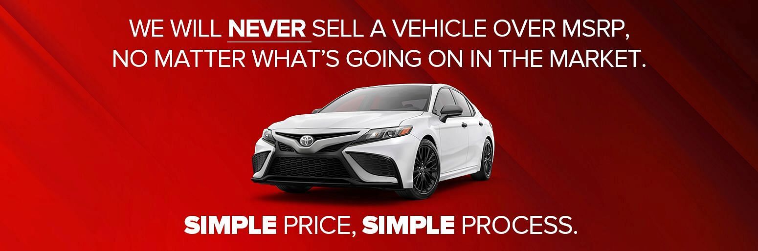 A white Toyota Camry on a red backgound - We Will Never Sell a Vehicle over MSRP, No Matter What's Going on in the Market