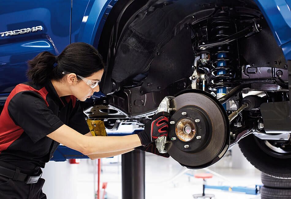 Service woman working on brakes