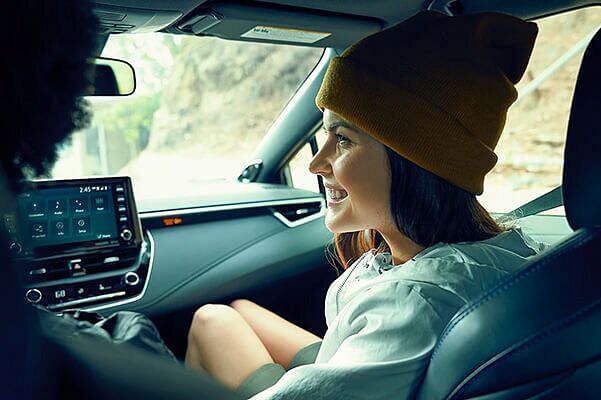 Smiling woman inside a Toyota Corolla car